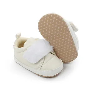 Detail of cream baby walker shoes with white fur trim and non-slip dotted sole