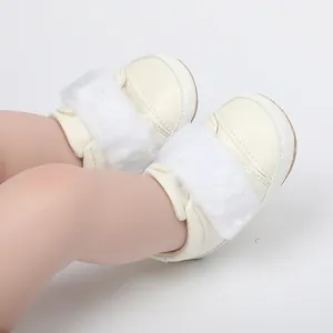 Close-up of cream baby princess shoes with white faux fur trim and soft sole detail