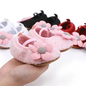 Detailed view of the pink fuzzy baby walker shoes with decorative 3D flower detail