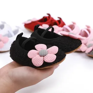 Close-up of black baby cotton shoes with pink flower and soft non-slip sole