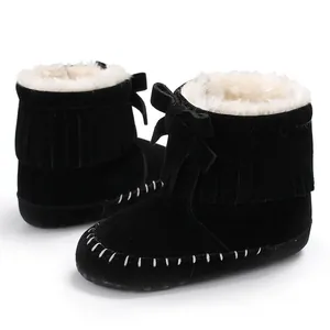 Detail view of black fringe baby boots with soft sole and warm white faux-fur lining