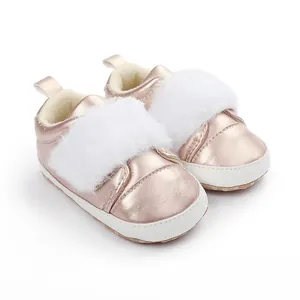 Close-up detailed view of pink metallic baby walker shoes with white faux fur trim.