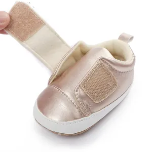 Close-up of rose gold baby girl pre-walker shoe with soft plush lining and velcro closure.