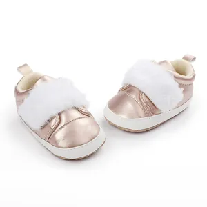 Detail of rose gold metallic baby shoes featuring soft white faux fur trim and non-slip sole