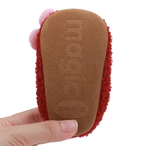 Detailed macro view showing the soft anti-slip brown sole of infant pre-walker cotton shoes