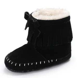 Detailed view of black tassel baby boots featuring soft faux fur lining and decorative bow