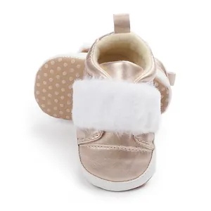 Top view of rose gold baby princess shoes with white faux fur detail for infants
