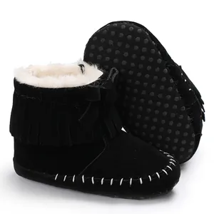 Detail showing black fringe baby boots with warm white fleece lining and soft anti-slip sole.