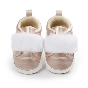 Close-up detail of rose gold baby girl walker shoes featuring a fluffy white faux fur strap