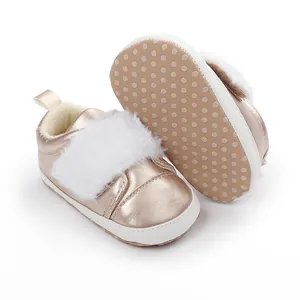 Detailed view of rose gold baby girl princess shoes with white faux fur and dot sole