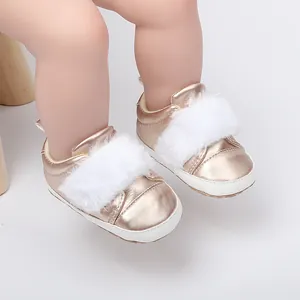 Detailed view of rose gold baby princess shoes with soft white faux fur trim.