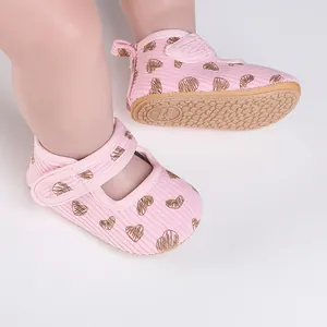 Pink baby walker shoes with heart patterns and high-grip non-slip rubber sole detail