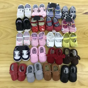 Detailed view of various colorful infant soft sole walking shoes arranged in rows