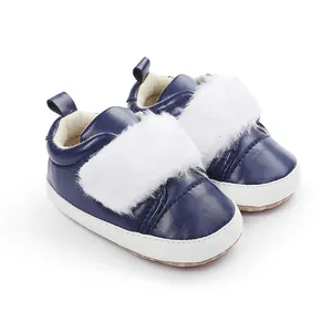 Close-up of navy blue baby girl shoes with soft white plush trim and non-slip soles.
