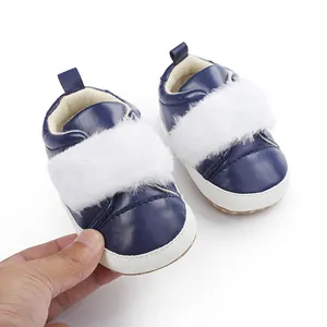 Detailed close-up of navy blue baby princess pre-walker shoes with white faux fur.