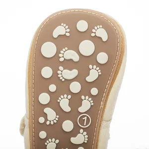 Close-up of baby walker shoe sole with anti-slip foot pattern and size marking