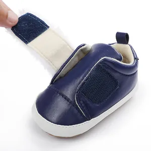 Detail view of navy blue baby princess shoe with open hook-and-loop strap and plush lining