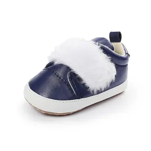 Navy blue baby shoes with white faux fur detail and soft non-slip soles for pre-walkers.