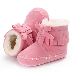 Pink suede infant walking boots featuring soft faux fur lining and fringe details.