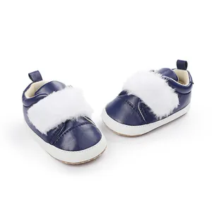 Detail view of navy blue baby girl shoes with soft soles and white faux fur trim