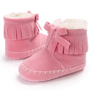 Detailed view of pink fringe baby walker boots with warm fleece lining