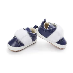 Detailed view of navy blue baby shoes with soft white faux fur trim and non-slip soles.