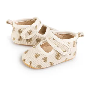 Close-up of baby walking shoes with heart pattern and soft ribbed fabric texture