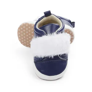 Detail view of navy blue baby shoes with white faux fur and non-slip soft soles