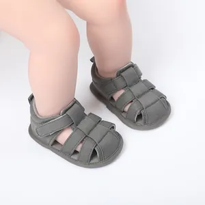 Primer plano de sandalias grises transpirables para bebés que aprenden a caminar