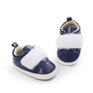 Navy blue baby girl pre-walker shoes featuring white faux fur trim and soft white soles