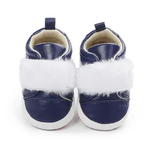 Detailed front view of navy blue baby girl princess shoes with soft white faux fur accent