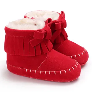 Detailed view of red suede baby fringe boots with bow and white stitching