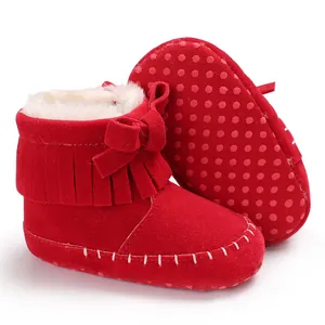 Close-up of red suede baby fringe walking shoes with soft non-slip sole and warm fur lining