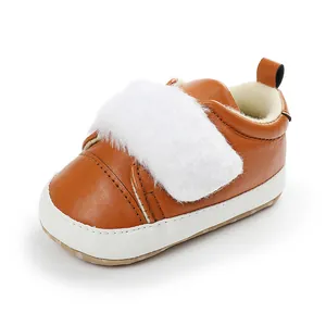 Detailed view of brown baby girl shoes with soft white faux fur strap and non-slip sole