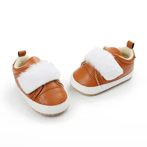 Detail view of brown baby girl pre-walker shoes with cute white faux fur trim and soft soles.