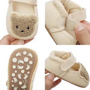 Detailed views of beige baby walker shoes featuring a plush bear patch and non-slip sole