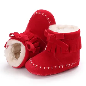Adorable red baby fringe boots featuring soft fleece lining and cute bow tie detail