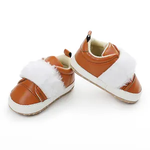 Detailed view of brown baby princess shoes with white faux fur trim and soft soles