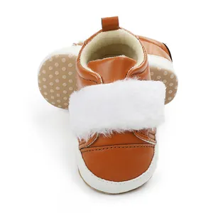 Detail view of brown baby walker shoes featuring soft white fur trim and non-slip dotted sole