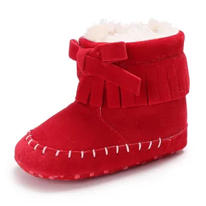 Classic red baby fringe booties with a soft sole and warm white faux fur lining for infants