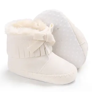 Detailed view of cream baby fringe boots featuring faux fur lining and anti-slip soft soles