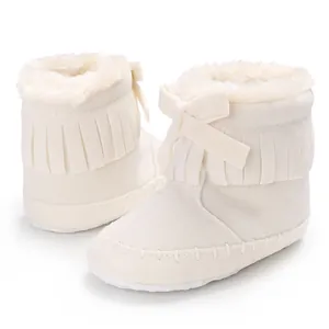 Detailed view of cream baby fringe walking boots with soft sole and faux fur lining