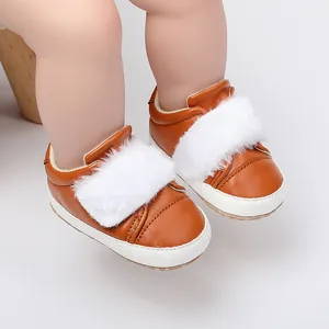 Close-up view of brown leather baby walking shoes with soft white faux fur collar detail