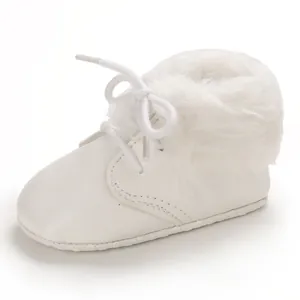 Detail view of white faux fur baby boots with soft anti-slip soles and white laces.