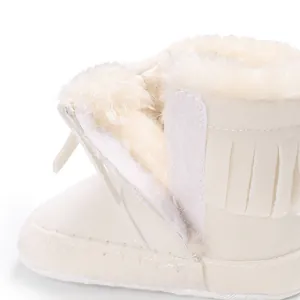 Detail view of white infant walking shoe featuring soft faux fur lining and velcro strap
