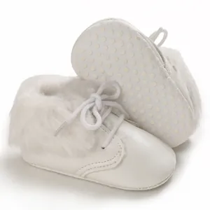 Minimalist white infant fur boots featuring soft non-slip soles and a classic lace-up design