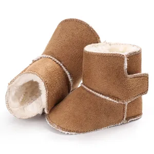 Detalle de botas cálidas para bebé con forro de piel sintética y velcro.