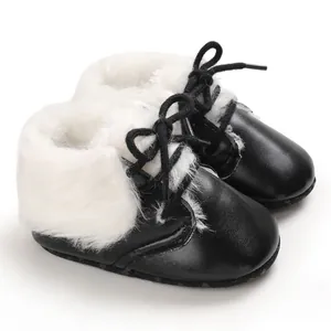Detailed view of black infant soft sole baby boots with white faux fur lining