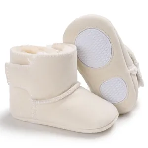 Detail van de antislip rubberen zolen en zacht suède op crème baby sneeuwlaarzen