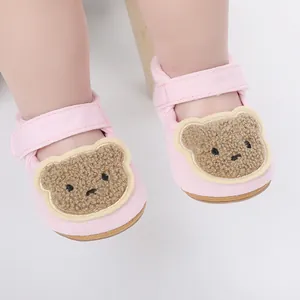 Detailed view of pink cotton baby walking shoes with a cute plush cartoon bear design